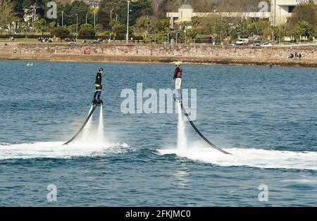 Fly-boarders in azione lungo il lungomare di Torquay in Devon. Foto Stock