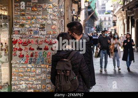 Barcellona, Spagna. 02 maggio 2021. Una coppia è vista guardando il merchandising souvenir per i turisti in via Argenteria a Ciutat Vella. Resta una settimana per lo stato di allarme decretato dal governo spagnolo a cessare a causa delle infezioni da Covid, ma Barcellona ha urgentemente bisogno del massiccio arrivo del turismo che visita la città per riattivare la sua economia e il commercio. (Foto di Paco Freire/SOPA Images/Sipa USA) Credit: Sipa USA/Alamy Live News Foto Stock