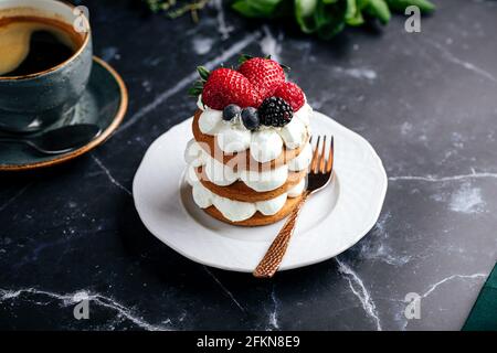 Torta di pan di zenzero sul piatto accanto a una tazza di caffè Foto Stock