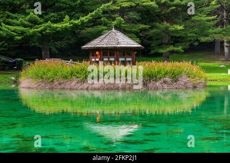 Piccola casa in legno che si riflette nel Lago di dover, Gressoney-Saint-Jean, Valle d'Aosta, Italia - Europa. Foto Stock