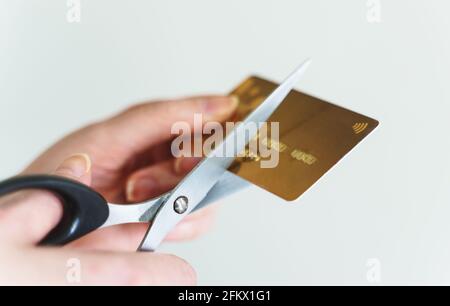Donna taglia la carta di credito con forbici. Foto Stock