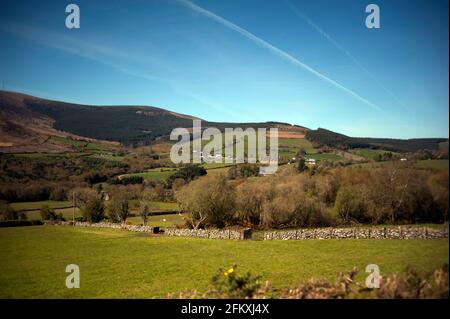 I percorsi di condensazione dagli aeroplani nel cielo sopra il Monte Leinster, lasciano i modelli di croce-croce nel cielo blu, contea Carlow, Irlanda, Europa Foto Stock