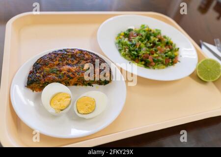 Omelette di carote, uova sode e piatti di menu insalata su vassoio pausa pranzo al concetto di fabbrica Foto Stock