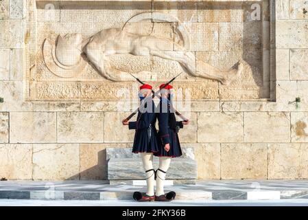Atene, Attica, Grecia. Evzones (soldati della Guardia Presidenziale greca) si trova ancora di fronte al monumento della tomba del soldato conosciuto Foto Stock