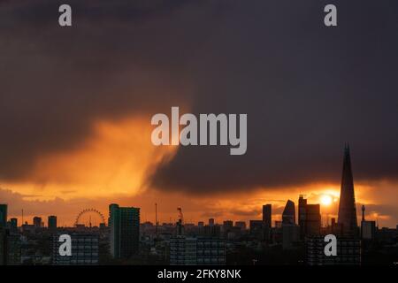 Londra, Regno Unito. 4 maggio 2021. Regno Unito Meteo: Drammatico rainstorm tramonto sulla città il Martedì sera. Credit: Guy Corbishley/Alamy Live News Foto Stock