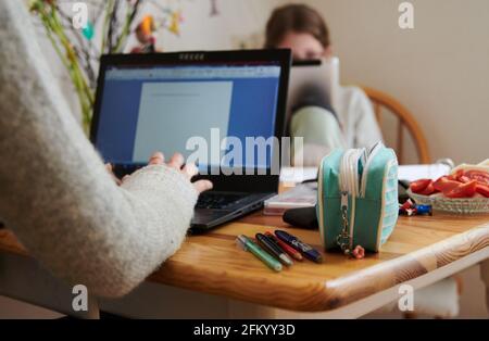 Berlino, Germania. 29 Apr 2021. Una madre lavora al tavolo da cucina mentre sua figlia guarda in un tablet di fronte. (A dpa 'più della metà dei dipendenti lavorano a casa') credito: Annette Riedl/dpa/Alamy Live News Foto Stock