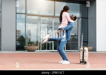 Reunion attesa da tempo. Happy excited African American Couple Meeting Near Airport Exit Foto Stock