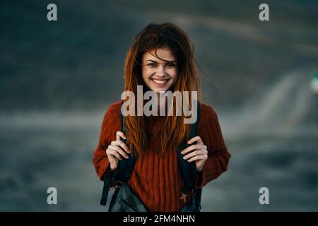 il viaggiatore felice in felpa rossa ride all'aperto vicino alle montagne all'aperto Foto Stock