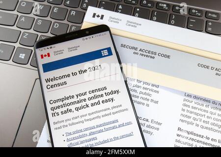 Toronto, Canada - 6 maggio 2021: Uno smartphone che mostra la home page del sito del censimento del Canada 2021 sulla lettera con il codice di accesso sicuro con una tastiera i Foto Stock