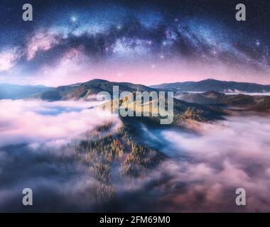 Latty Way si inarca sulle montagne in basse nuvole a. notte stellata Foto Stock