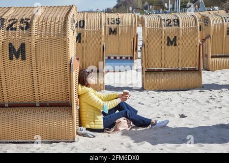 06 maggio 2021, Schleswig-Holstein, Kiel: Monika Veselsky gode del sole sulla spiaggia. Dopo la decisione di ulteriori passi di apertura nel turismo e nella gastronomia dello Schleswig-Holstein, la regione si prepara. Foto: Georg Wendt/dpa Foto Stock