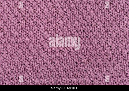 Tessuto lavorato a maglia sfondo di lana perla. La struttura del tessuto con una texture naturale. Sfondo tessuto. Sfondo di lana lavorato a maglia. Foto Stock