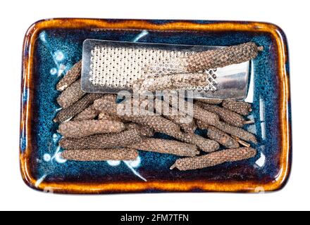 vista dall'alto di giava, lunghi cetrioli di pepe e grattugia scodella in ceramica tagliata su sfondo bianco Foto Stock