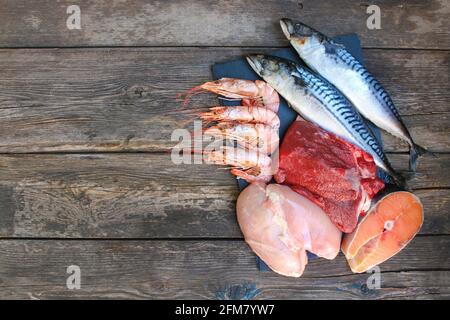 Cibo sano di origine animale su vecchio sfondo di legno. Concetto di nutrizione adeguata. Foto Stock