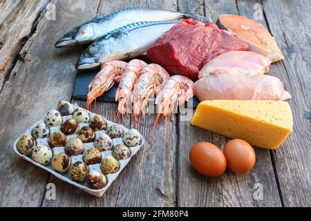 Cibo sano di origine animale su vecchio sfondo di legno. Concetto di nutrizione adeguata. Foto Stock