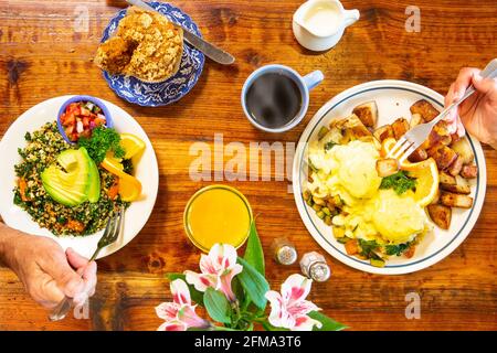 Le uova vegetariane Benedict e una scramble vegana sono goduti da due liberi Foto Stock