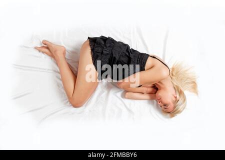 Woman lies asleep in bed Foto Stock