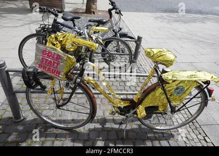 Weimar, Germania. 8 maggio 2021. I panni color oro sono avvolti intorno a una bicicletta. Con il motto "Oro anziché marrone", varie associazioni, sindacati e iniziative della Turingia hanno richiesto azioni speciali in occasione dell'anniversario della liberazione dal nazionalsocialismo l'8 maggio 2021. Credit: Bodo Schackow/dpa-Zentralbild/dpa/Alamy Live News Foto Stock