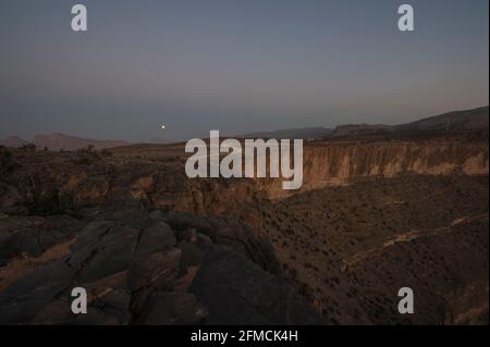 Luna piena sopra Jebel Shams, il Grand Canyon dell'Arabia. Regione di al Dakhiliyah, Oman Foto Stock