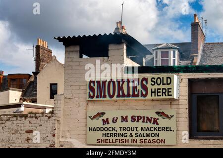 ARBROATH ANGUS SCOTLAND SEGNO PER M & M SPINK ARBROATH PESCE SMOKIES VENDUTO QUI CON FUMO CHE VERSA DAL CAMINO Foto Stock