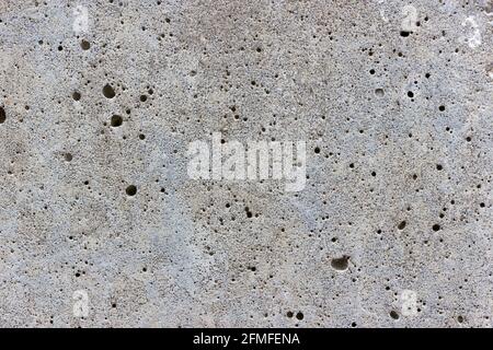 Una superficie piana in cemento grigio testurizzato coperta da bolle d'aria Foto Stock