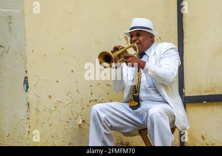 L'AVANA, CUBA - 4 LUGLIO 2017: Uomo non identificato che suona la tromba sulla strada dell'Avana, Cuba. I musicisti di strada sono comuni a l'Avana dove suonano mus Foto Stock