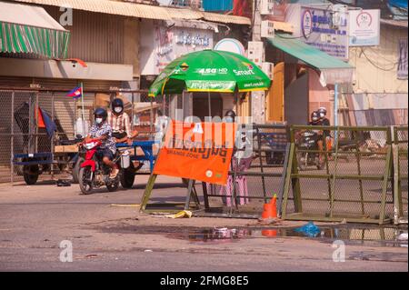 Phnom Penh, Cambogia. 9 maggio 2021. Dopo 3 settimane di chiusura totale della città, il governo cambogiano ha diviso Phnom Penh in 3 zone colorate (rosso, arancione e giallo) a causa dell'aumento COVID - 19 in corso. Il traffico passa attraverso un checkpoint della polizia all'ingresso di una 'zona arancione', che significa medio rischio di infezione. Credit: Kraig Lieb / Alamy Live News Foto Stock