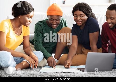 Allegri amici afro-americani in cerca di destinazione per viaggiare Foto Stock