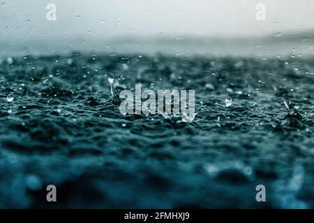 Gocce che colpiscono la superficie dell'acqua Ocean Sea Rain gocce Foto Stock