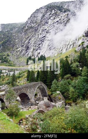 L'Haderlisbrucke, ponte in pietra ad arco del 1649 sul fiume Reuss, nella gola di Schollenen vicino a Goschenen, Svizzera Foto Stock