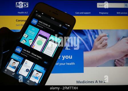 Servizio sanitario nazionale (o NHS) app sulla silhouette di uno smartphone tenere a portata di mano Foto Stock