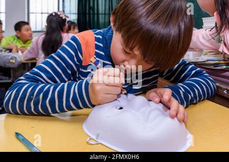 Gli studenti primari di una scuola rurale di Xiuning, Anhui, Cina che fanno opere d'arte. Foto Stock