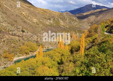 Il fiume Kawarau nella regione di Otago, Isola del Sud, Nuova Zelanda, passando attraverso un paesaggio montano autunnale Foto Stock