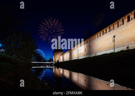 un divertente festival della città termina con un festoso spettacolo di fuochi d'artificio. le colorate esplosioni di fuochi d'artificio nel cielo serale si riflettono nell'acqua Foto Stock