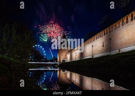 un divertente festival della città termina con un festoso spettacolo di fuochi d'artificio. le colorate esplosioni di fuochi d'artificio nel cielo serale si riflettono nell'acqua Foto Stock