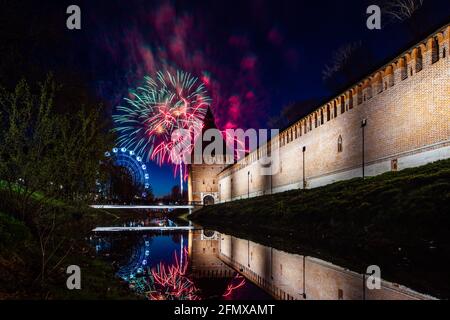 un divertente festival della città termina con un festoso spettacolo di fuochi d'artificio. le colorate esplosioni di fuochi d'artificio nel cielo serale si riflettono nell'acqua Foto Stock