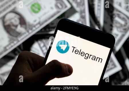 Cina. 23 Apr 2021. In questa illustrazione fotografica il logo del telegramma di messaggistica istantanea basato su cloud visualizzato su uno smartphone con la valuta USD (dollaro statunitense) in background. Credit: SOPA Images Limited/Alamy Live News Foto Stock