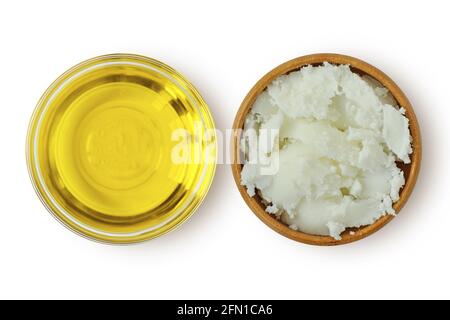 Olio di argan in recipiente di vetro e burro di karité karité karité ciotola di legno su sfondo bianco Foto Stock