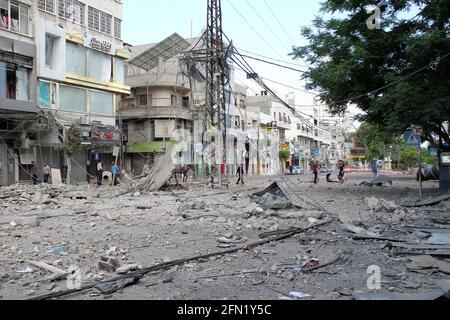 (210513) -- CITTÀ DI GAZA, 13 maggio 2021 (Xinhua) -- i palestinesi ispezionano i negozi danneggiati a seguito di attacchi aerei israeliani a Gaza, il 13 maggio 2021. La tensione tra Israele e i gruppi militanti nella striscia di Gaza è proseguita giovedì, mentre i funzionari del ministero della sanità gestito da Hamas hanno affermato che il numero delle vittime nell'enclave costiera assediata è salito a 83. Il ministero della salute a Gaza ha detto in un breve messaggio di testo inviato ai giornalisti che dall'inizio della tensione di lunedì, 83 palestinesi sono stati uccisi, tra cui 17 bambini e sette donne, aggiungendo che 487 sono stati feriti. (Foto di Rizek Abdeljawad/Xinhu Foto Stock