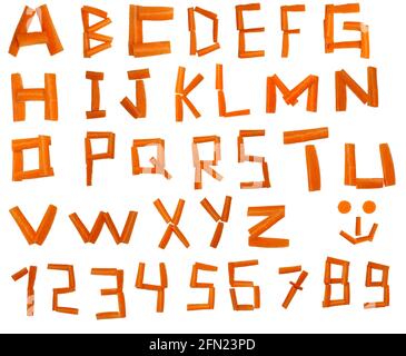 Lettere fatte da bastoni vegetali di carote, disposte in alfabeto e numeri Foto Stock
