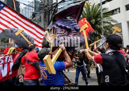 Gli attivisti distruggono un effigie del presidente filippino Rodrigo Duterte con i martelli durante una protesta in occasione della festa del lavoro a Quezon City. Vari gruppi hanno chiesto diritti e benefici adeguati in materia di lavoro, come l'aumento minimo dei salari, l'assistenza finanziaria e le prove di massa dovute al COVID-19. Metro Manila, Filippine. Foto Stock