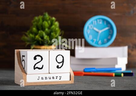 29 gennaio. Gennaio 29 calendario cubo di legno con oggetti sfocati sullo sfondo. Foto Stock