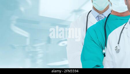 Sezione centrale del team di medici e operatori sanitari contro ospedale in background Foto Stock