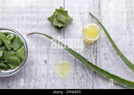 Pezzi di pianta di aloe con gel all'interno in una ciotola di vetro primo piano. Medicina alternativa. Raccolta di succo di aloe, per il trattamento di malattie della pelle Foto Stock