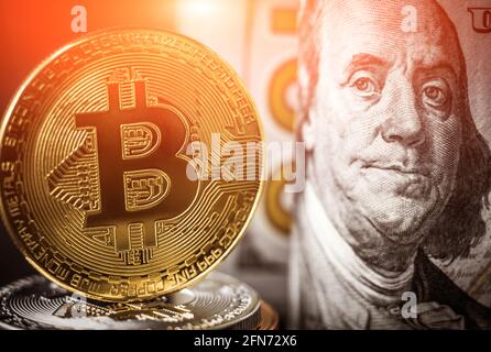 Moneta bitcoin d'oro davanti alle banconote in dollari. Nuovo concetto di denaro virtuale Foto Stock