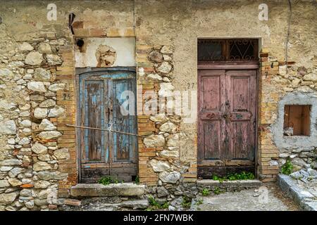 Ingresso maschile e ingresso femminile. Due porte di vecchie case dipinte di colore rosa e blu. Concetto di maschio e femmina. Abruzzo, Italia, Europa Foto Stock