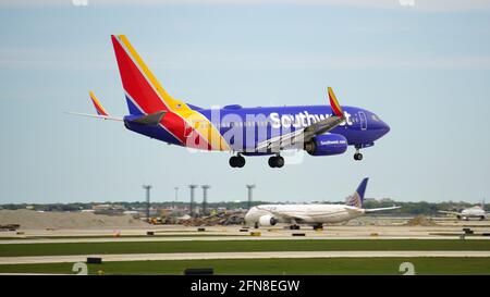 Il Boeing 737-700 della Southwest Airlines si avvicina alla pista per atterrare a Chicago o'Hare. Un aereo di United Airlines tassa su un'altra pista in background. Foto Stock