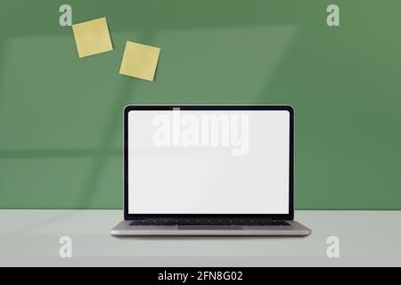 Spazio di lavoro minimo con computer portatile mock-up schermo vuoto attivato muro d'epoca color pastello a casa Foto Stock