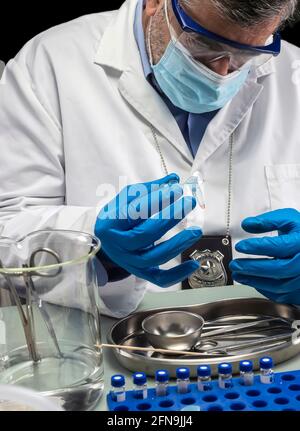 Lo scienziato della polizia tiene una fiala con una traccia di sangue sul tampone per indagare l'omicidio nel laboratorio di criminalità, immagine concettuale Foto Stock