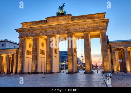 La porta di Brandeburgo con la torre della televisione sul retro prima dell'alba, visto a Berlino, Germania Foto Stock